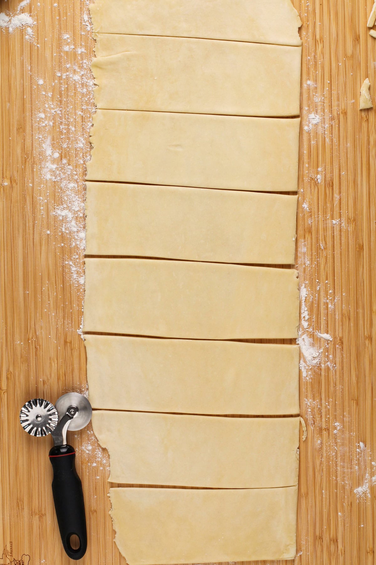 Pie dough rolled into a long rectangle and cut into strips.