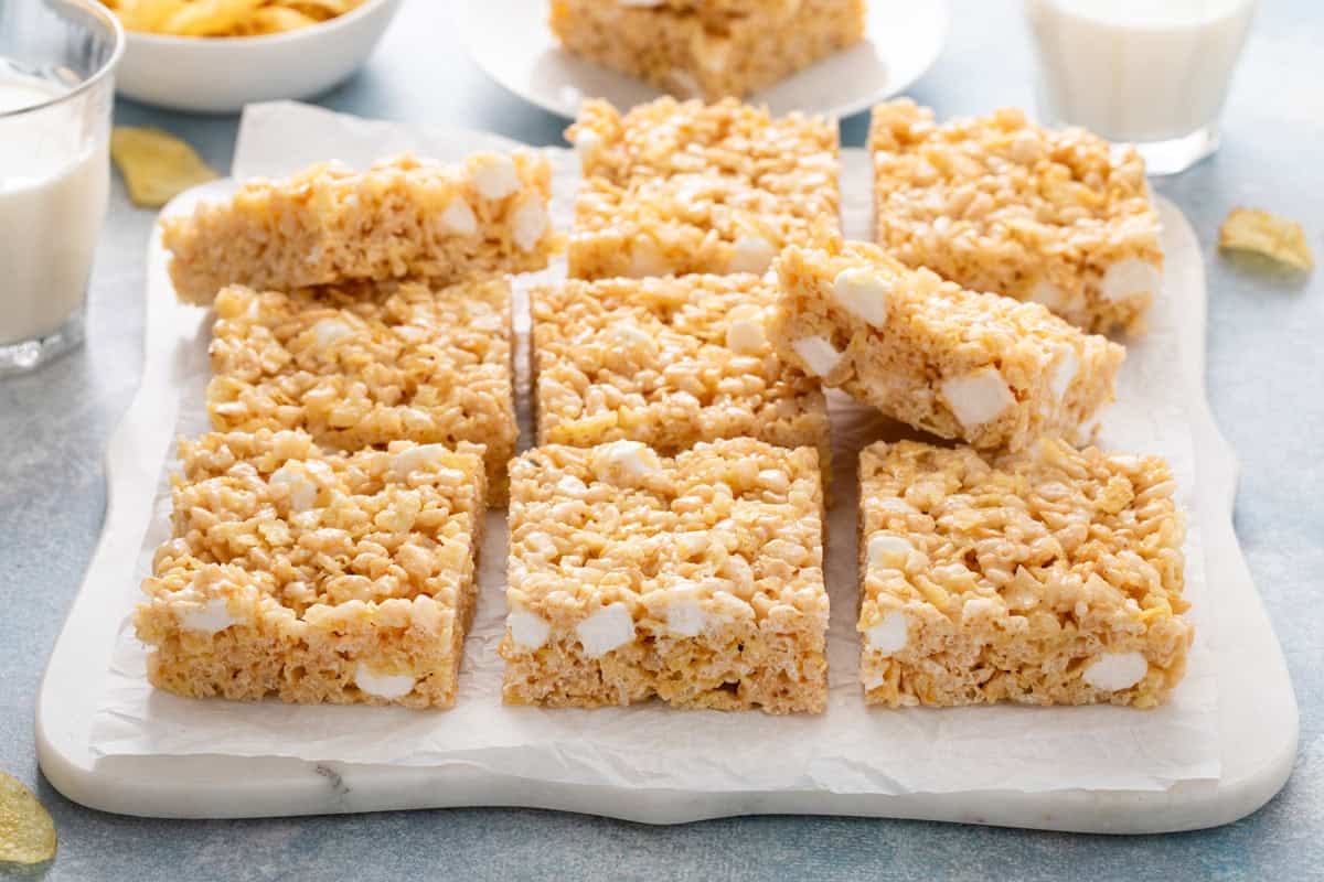 Side view of sliced potato chip rice krispie treats on a white platter.