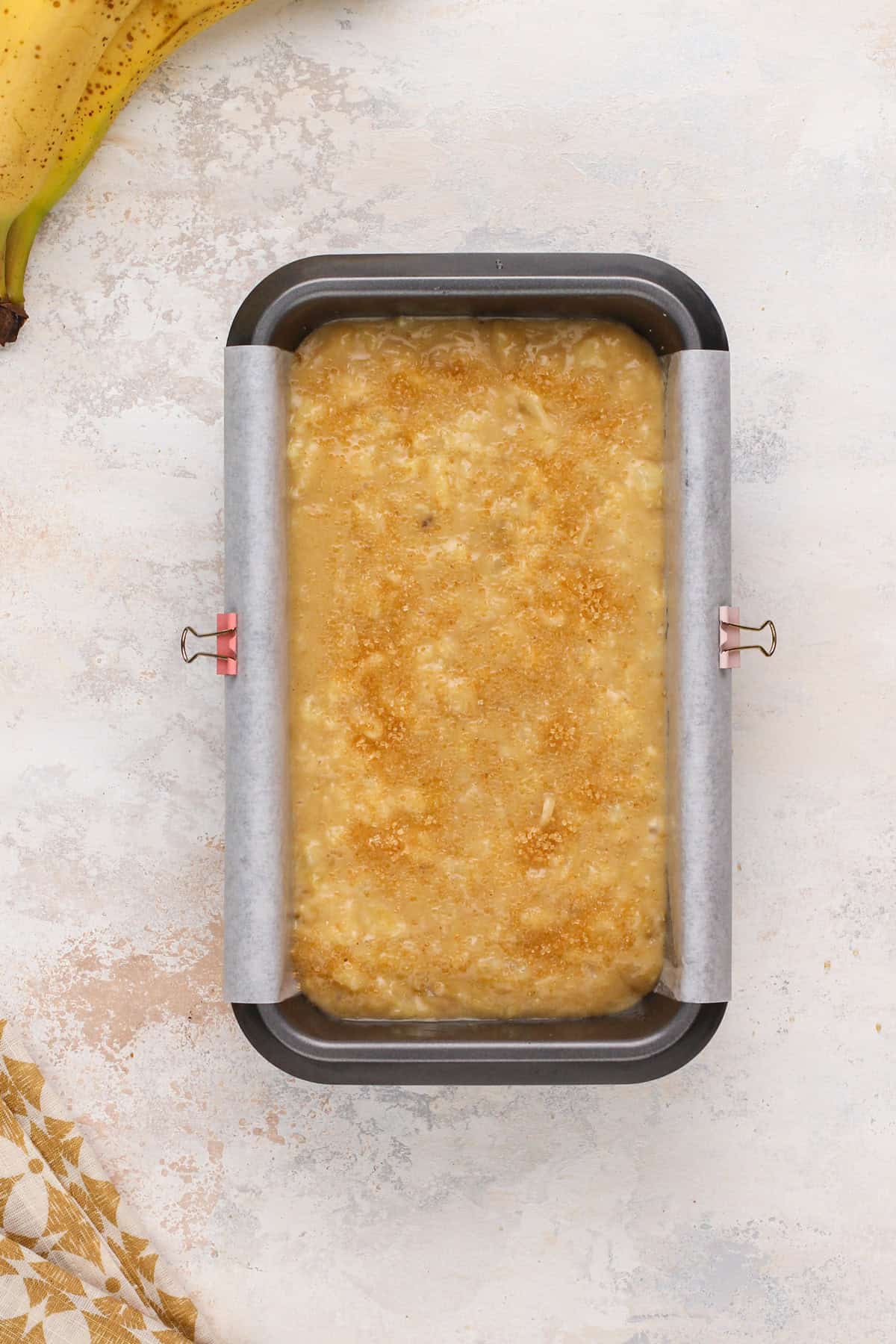 Unbaked pineapple banana bread in a loaf pan, ready to go in the oven.