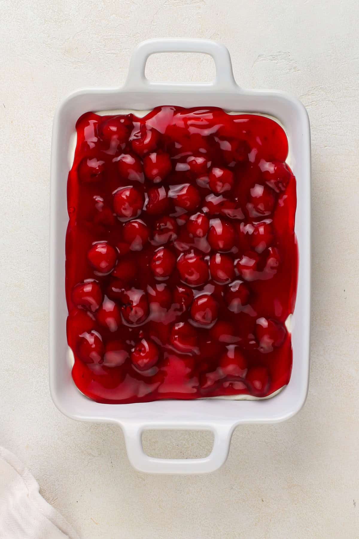 Cherry cheesecake dip assembled in a white dish.