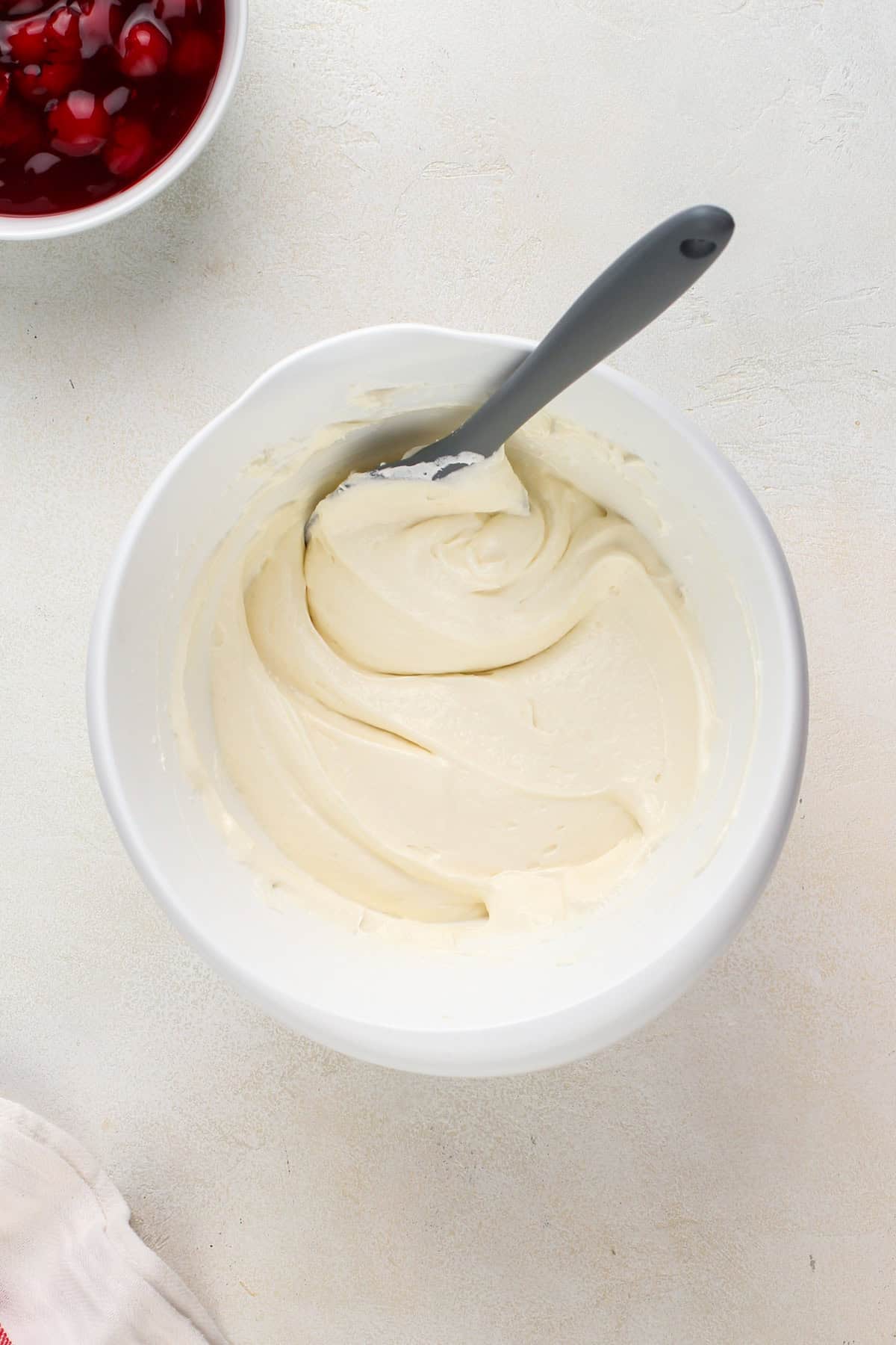 Cheesecake dip base mixed in a white bowl.