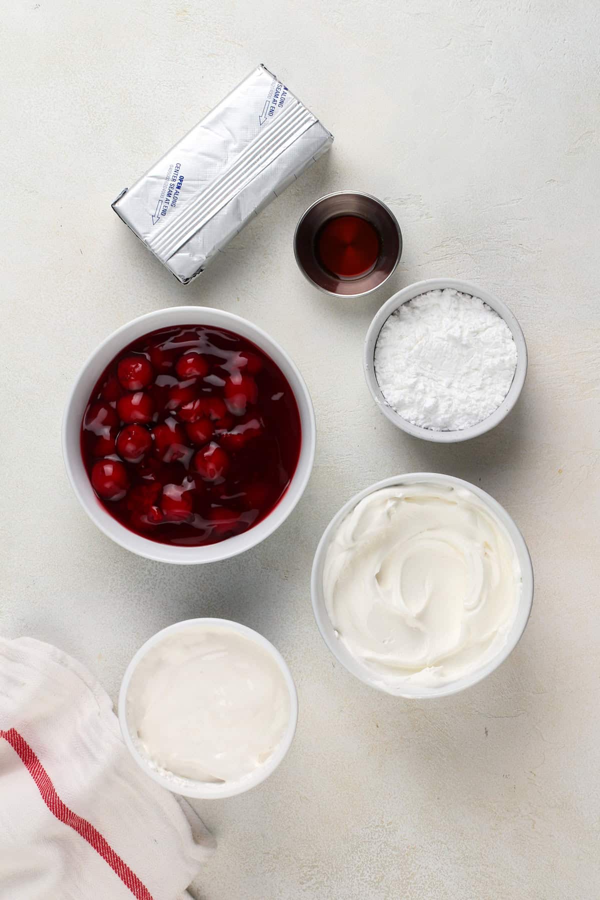 Cherry cheesecake dip ingredients arranged on a countertop.