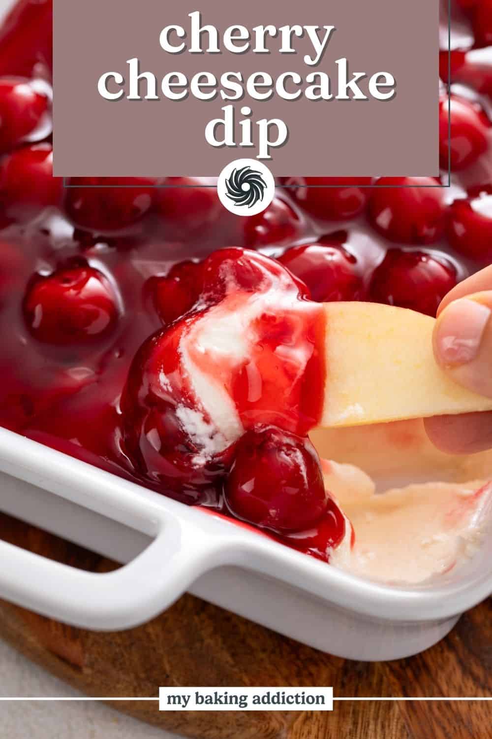 Apple slice being dipped into a dish of cherry cheesecake dip. Text overlay includes recipe name.