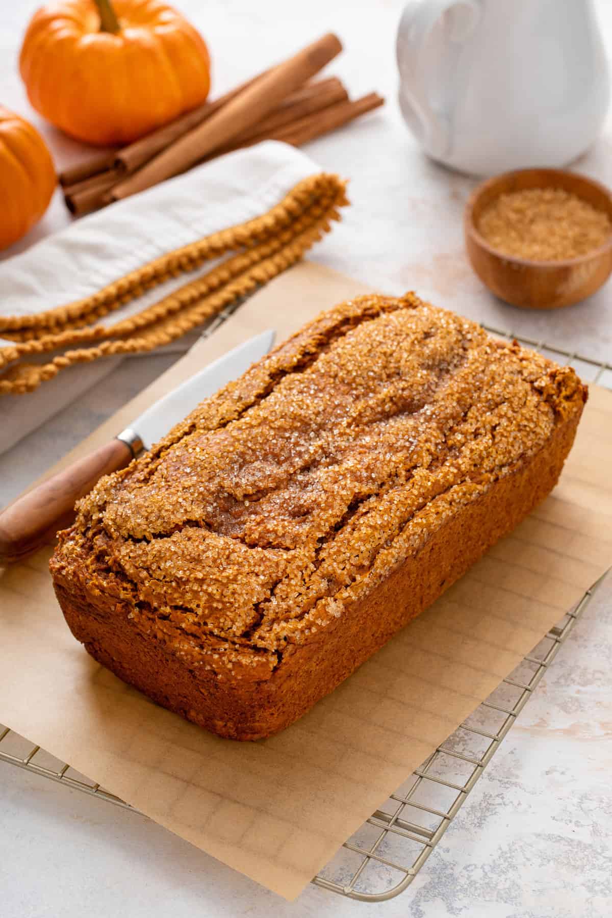 Cooling loaf of 2-ingredient pumpkin bread on a wire rack.