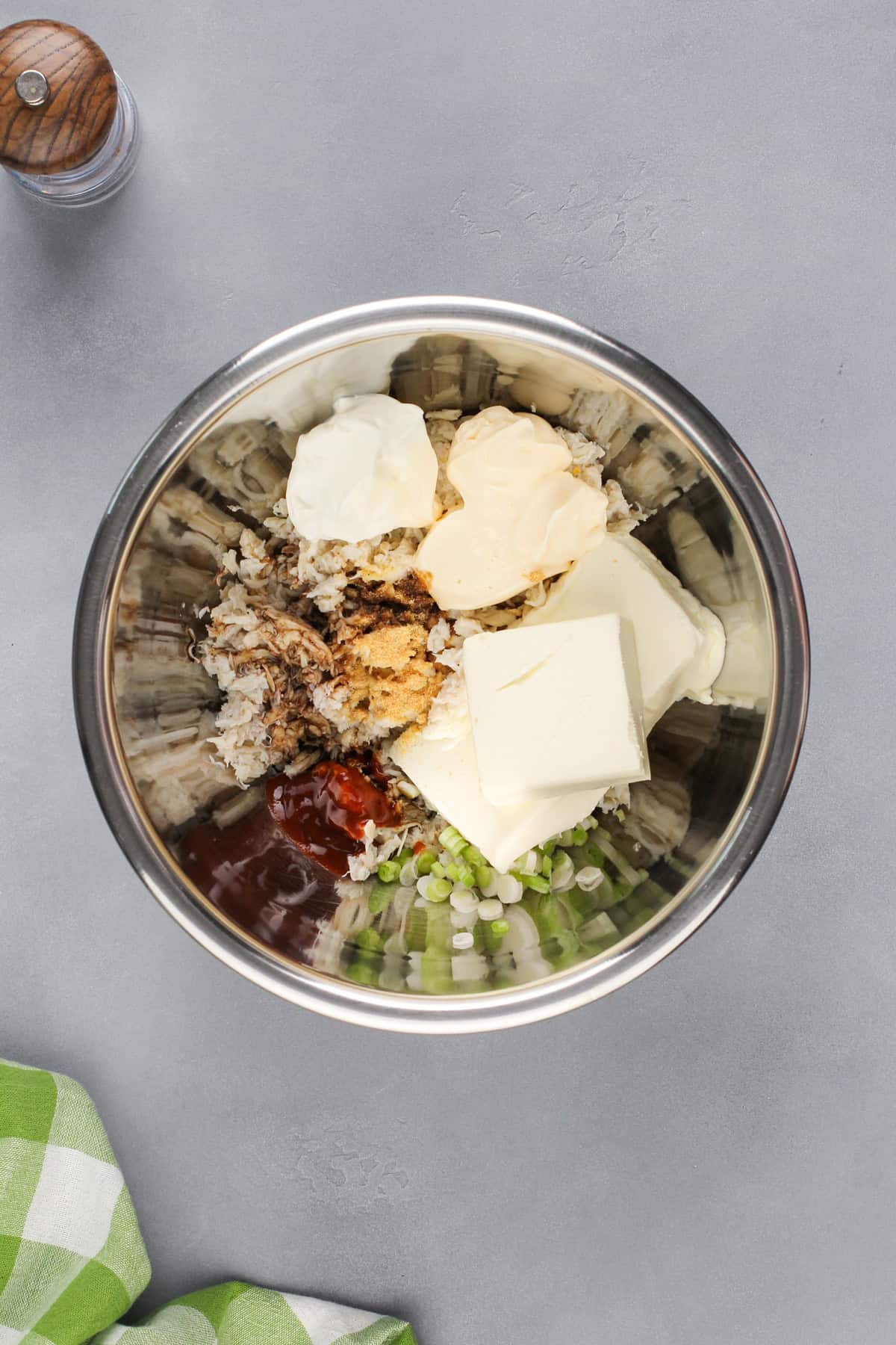 Mixing bowl filled with the ingredients for crab rangoon dip.