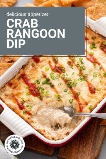 Spoon in the corner of a baking dish filled with crab rangoon dip. Text overlay includes recipe name.