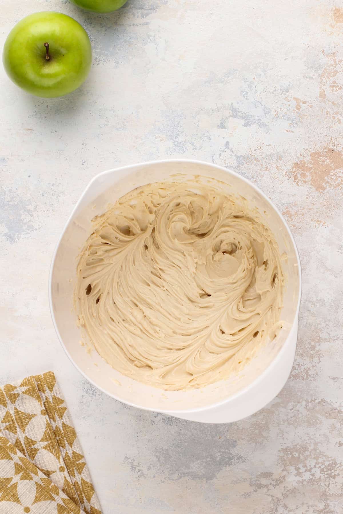 Cream cheese mixture in a mixing bowl for apple dip.