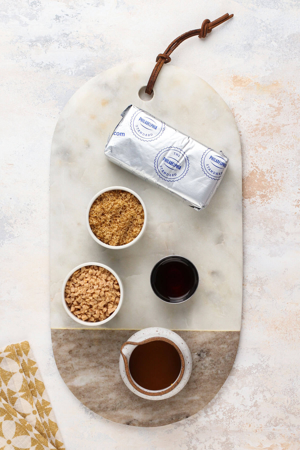 Ingredients for cream cheese caramel apple dip arranged on a countertop.