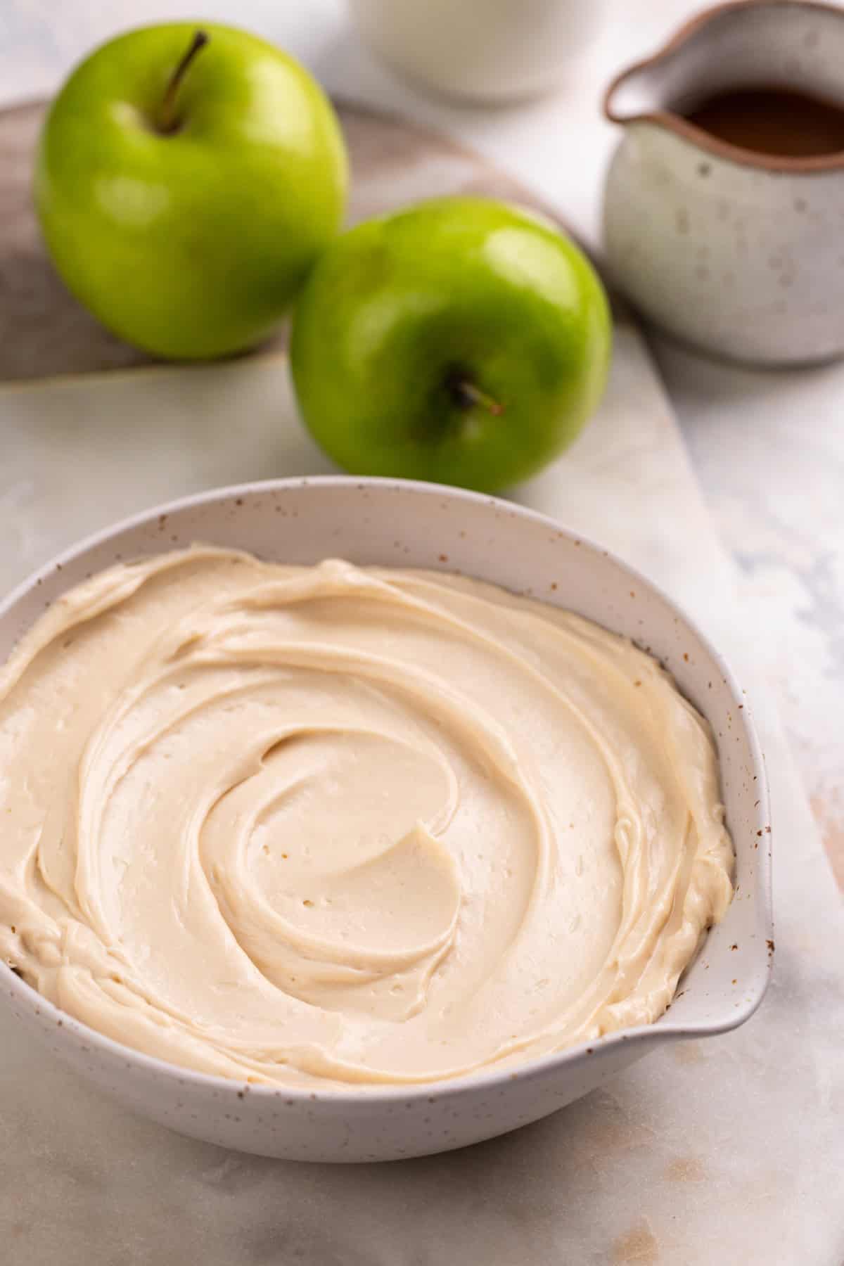 Cream cheese mixture for apple dip spread into a bowl.