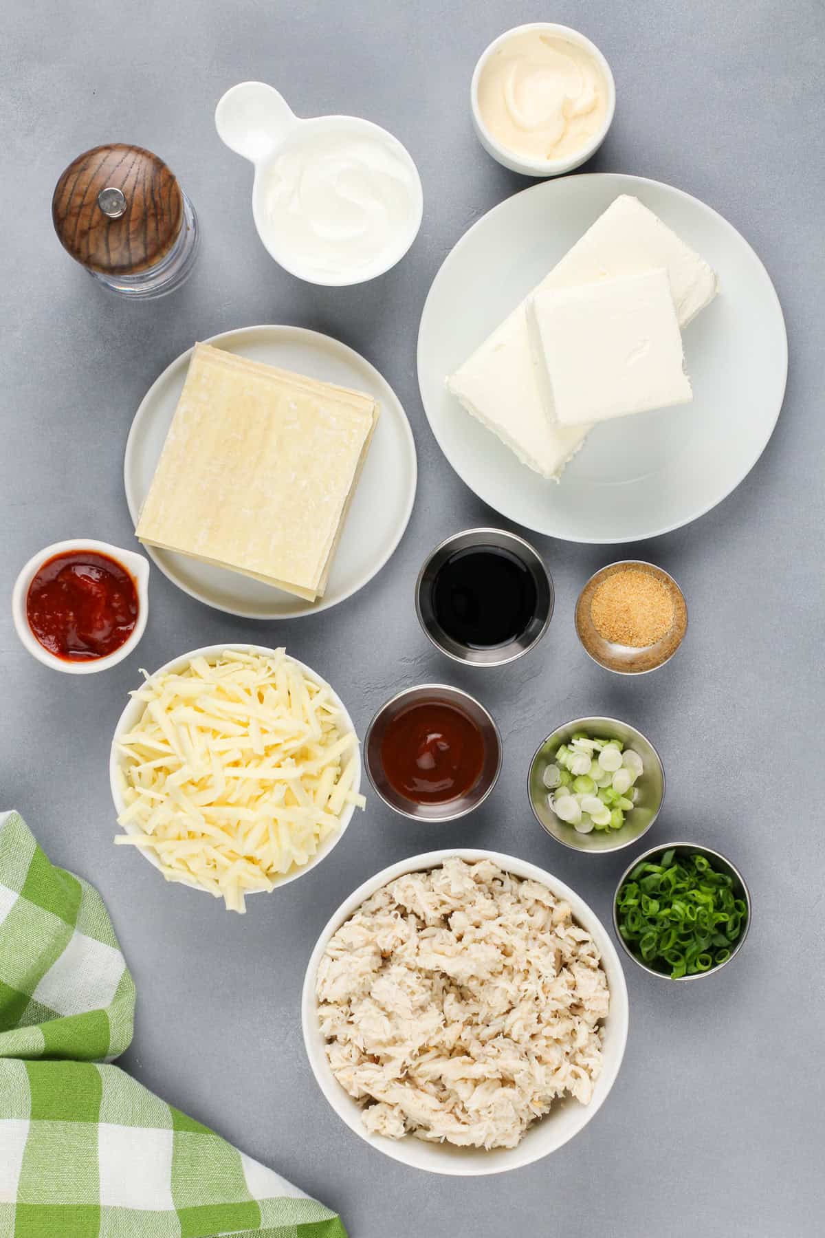 Crab rangoon dip ingredients arranged on a countertop.