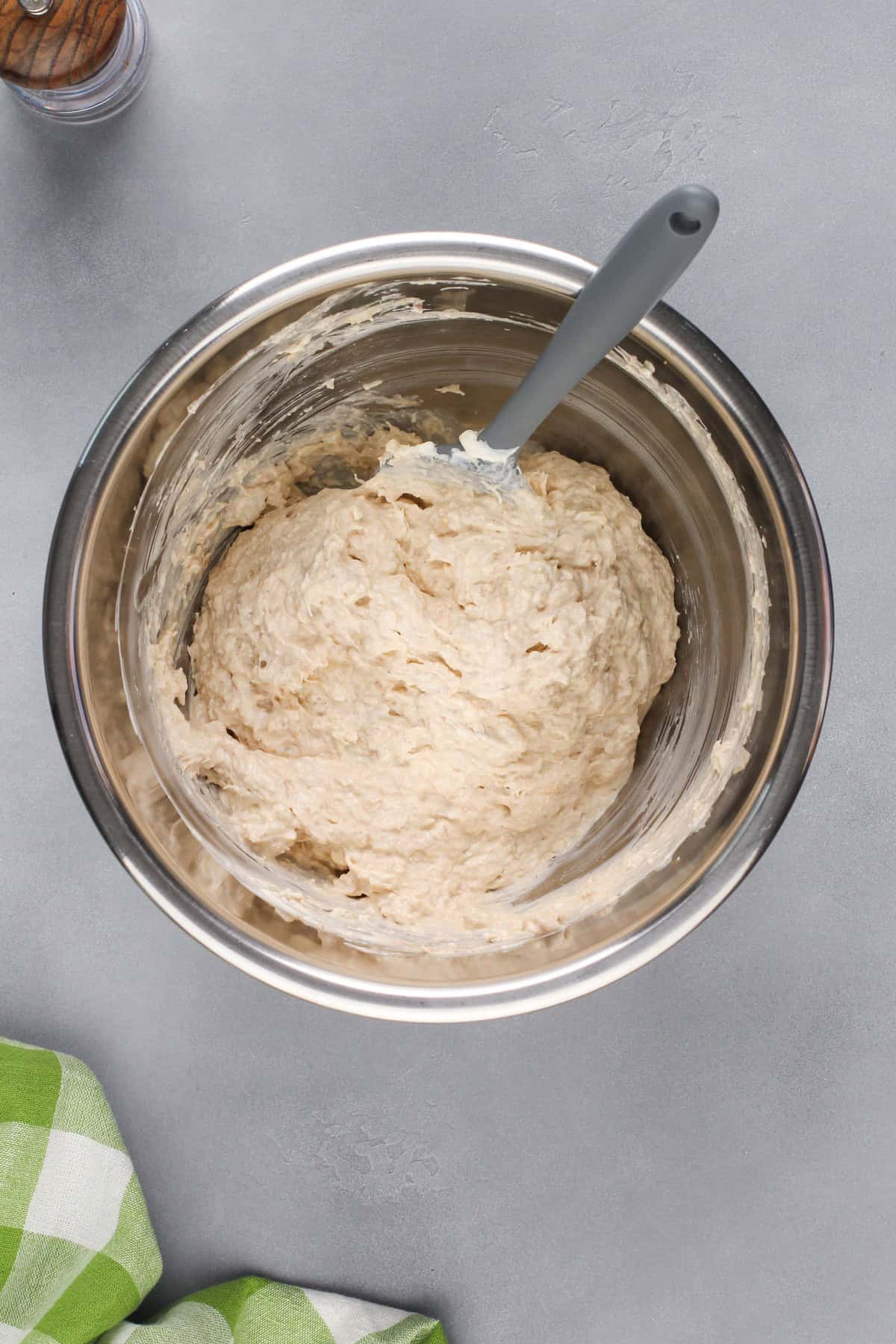 Crab rangoon dip being mixed in a metal bowl.