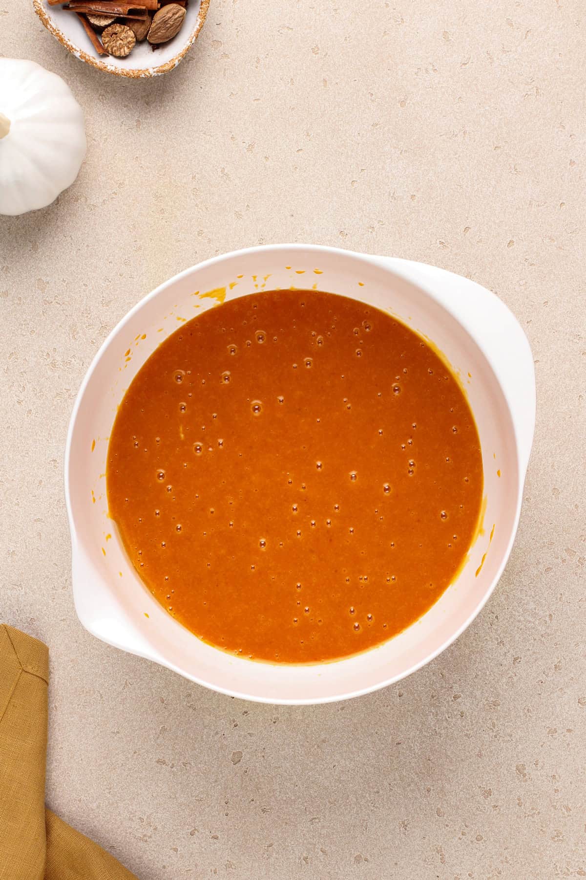 Wet ingredients for pumpkin bars combined in a bowl.