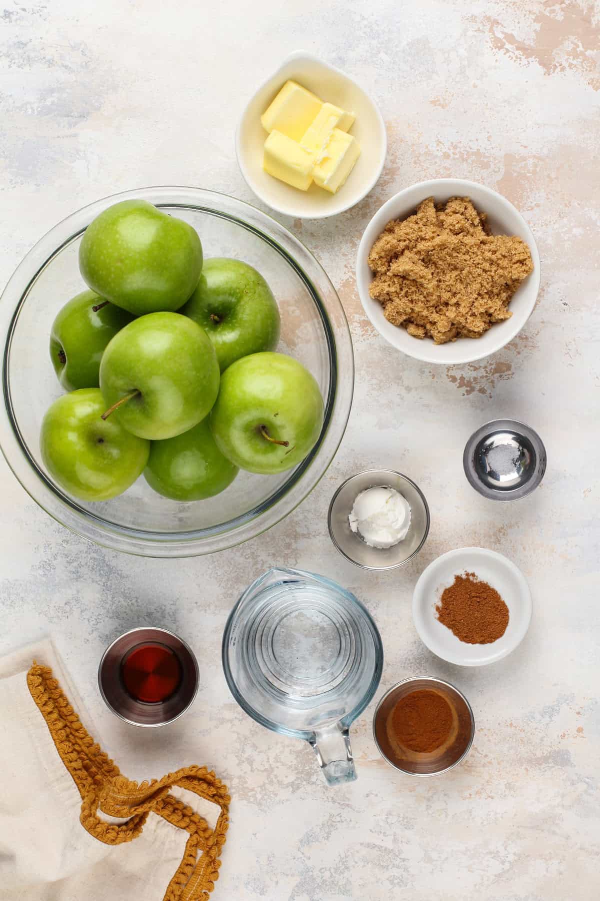 Ingredients for sauteed apples arranged on a countertop.