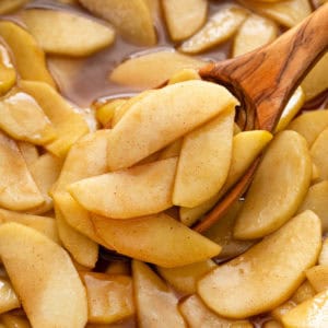 Wooden spoonful of sauteed apples.