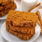 Stacked slices of 2-ingredient pumpkin bread on a white plate.