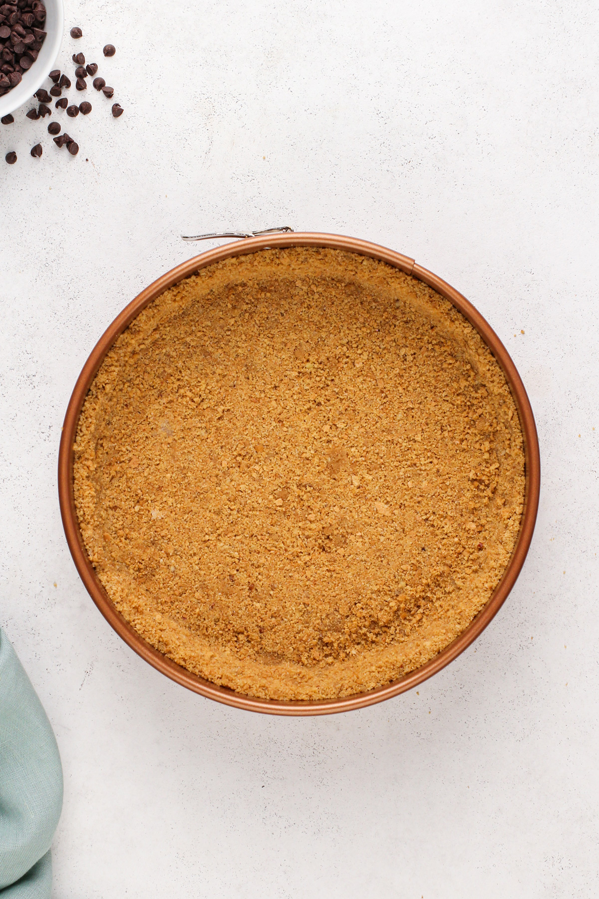 Graham cracker crust in a springform pan.