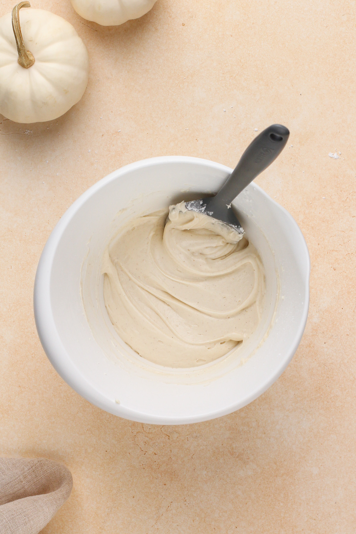 Cream cheese frosting mixed in a white bowl.