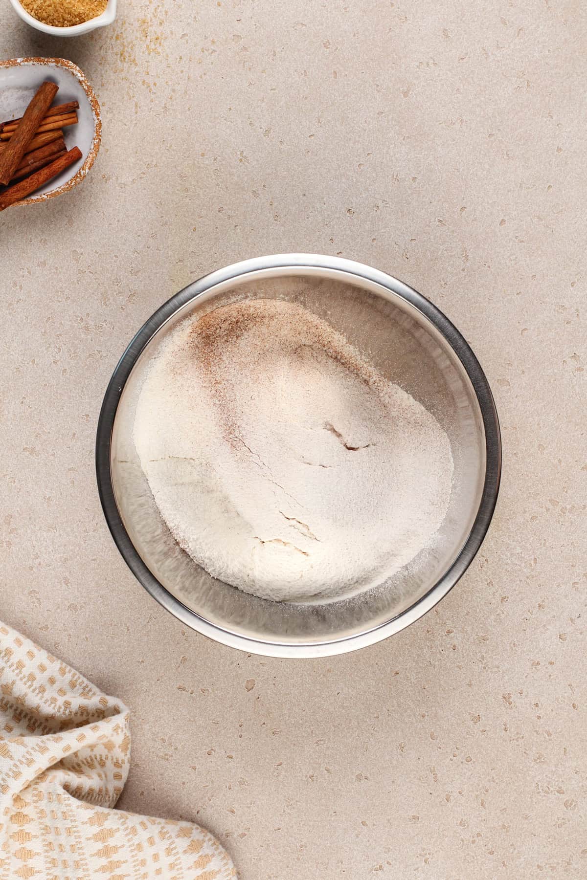 Dry ingredients for brown sugar cookies in a metal mixing bowl.