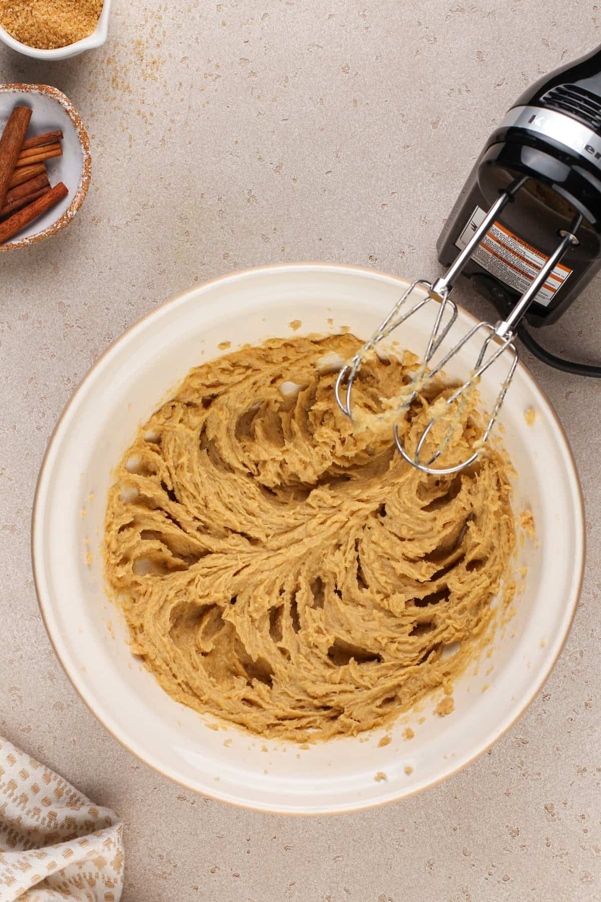 Wet ingredients for brown sugar cookies mixed together in a ceramic mixing bowl.