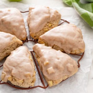 Glazed apple scones on a wire rack.