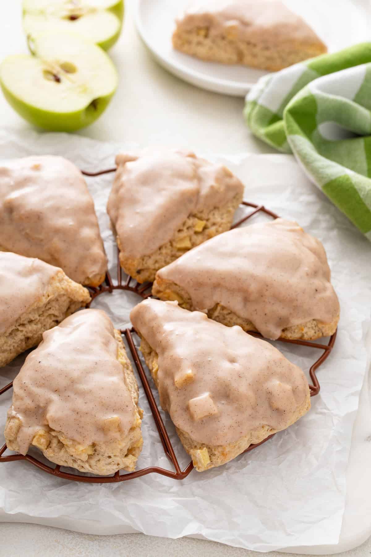 Glazed apple scones cooling on a rack.