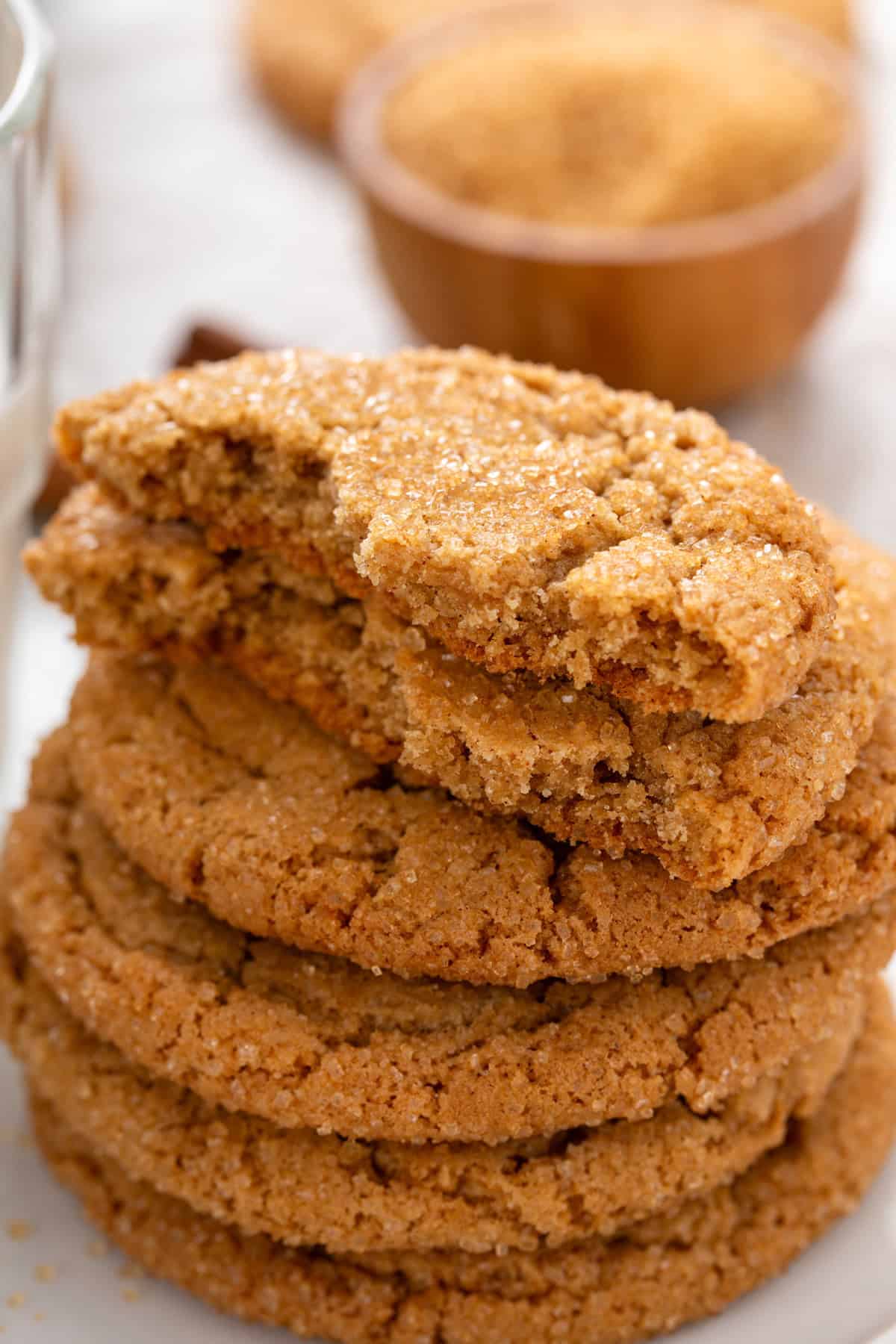 Halved brown sugar cookie on top of a stack of cookies.