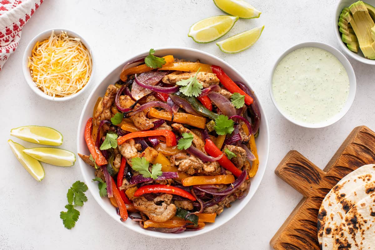 Overhead view of a bowl of sheet pan chicken fajitas.