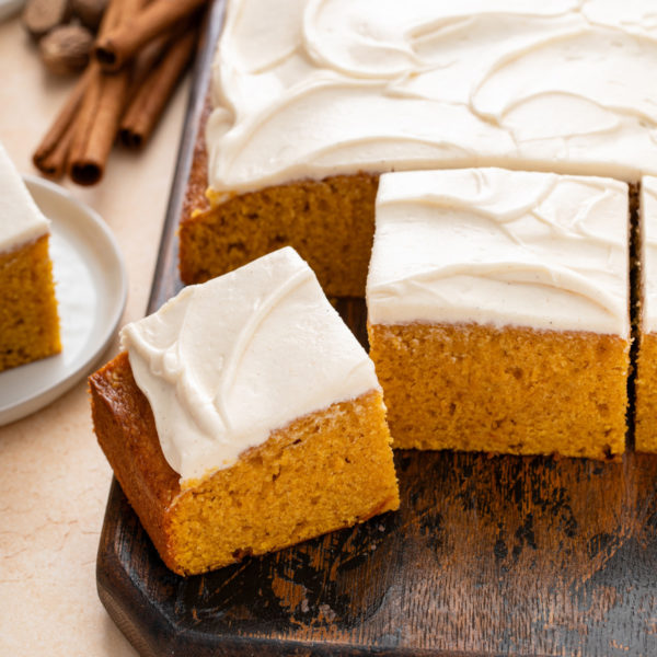 Slices of pumpkin cake on a wooden board.