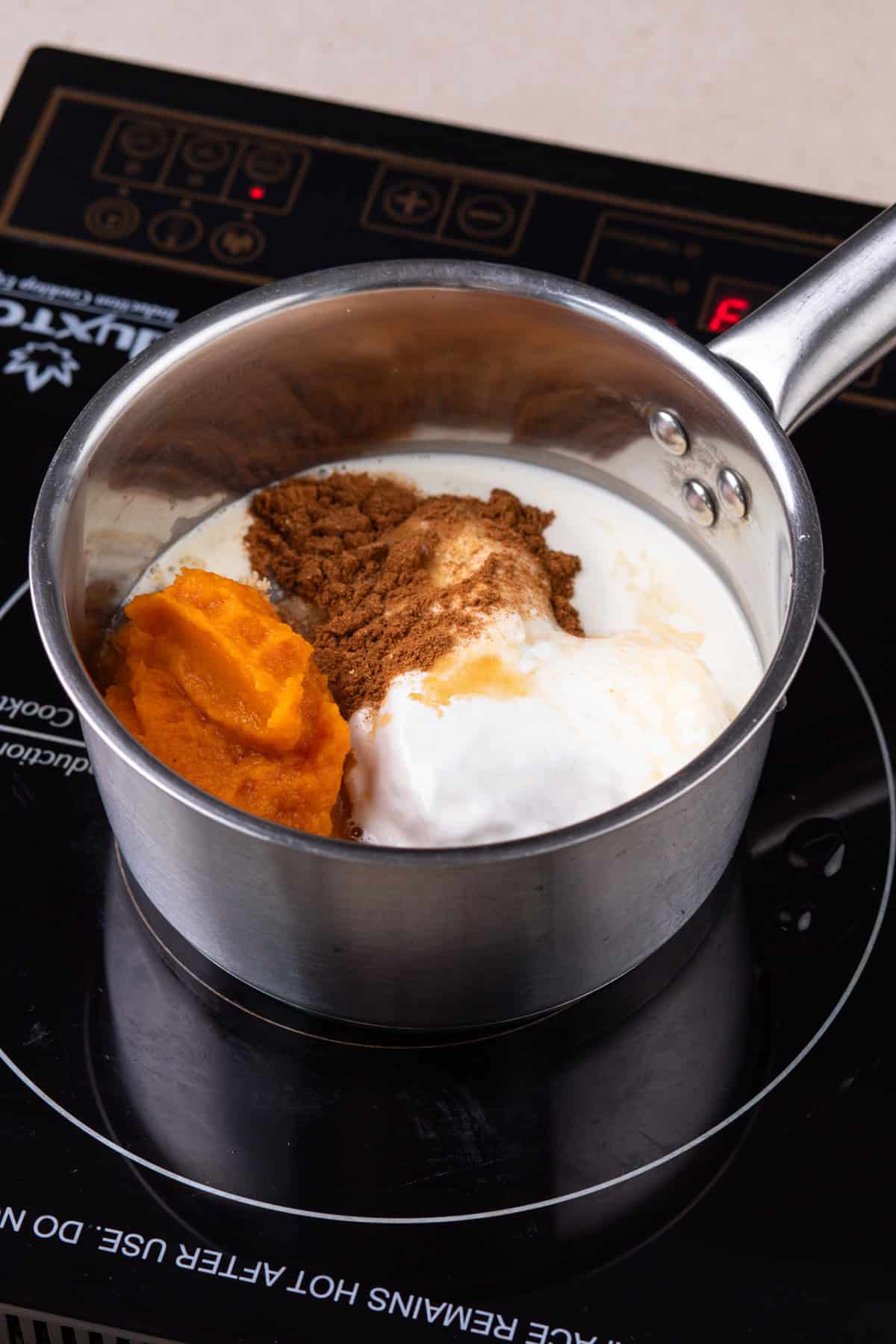 Ingredients for pumpkin coffee syrup in a saucepan.