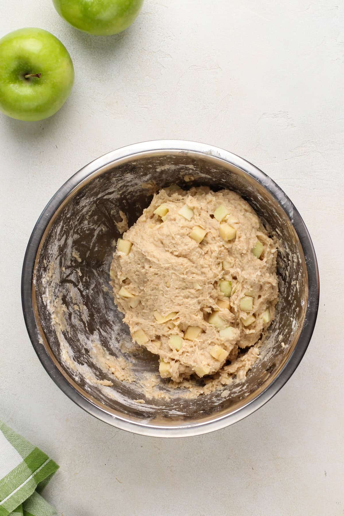 Apple muffin dough pressed into a ball in a metal container.