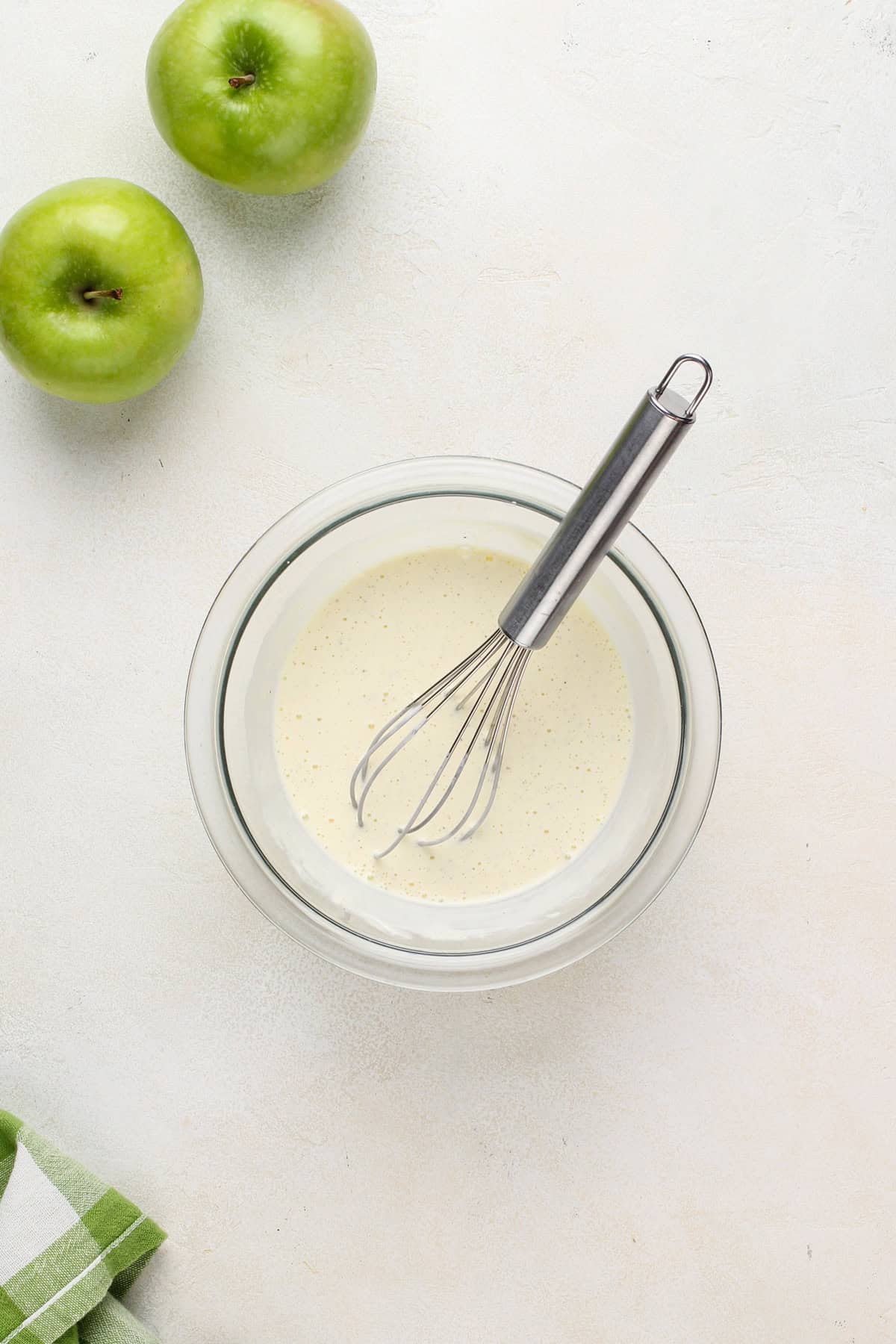 Wet ingredients for apple scones whisked together in a bowl.