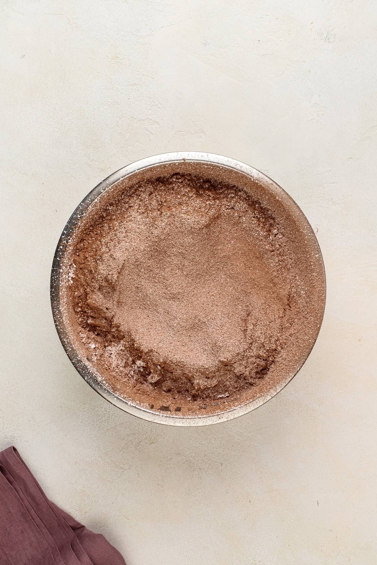 Powdered sugar and cocoa powder sifted together in a bowl.