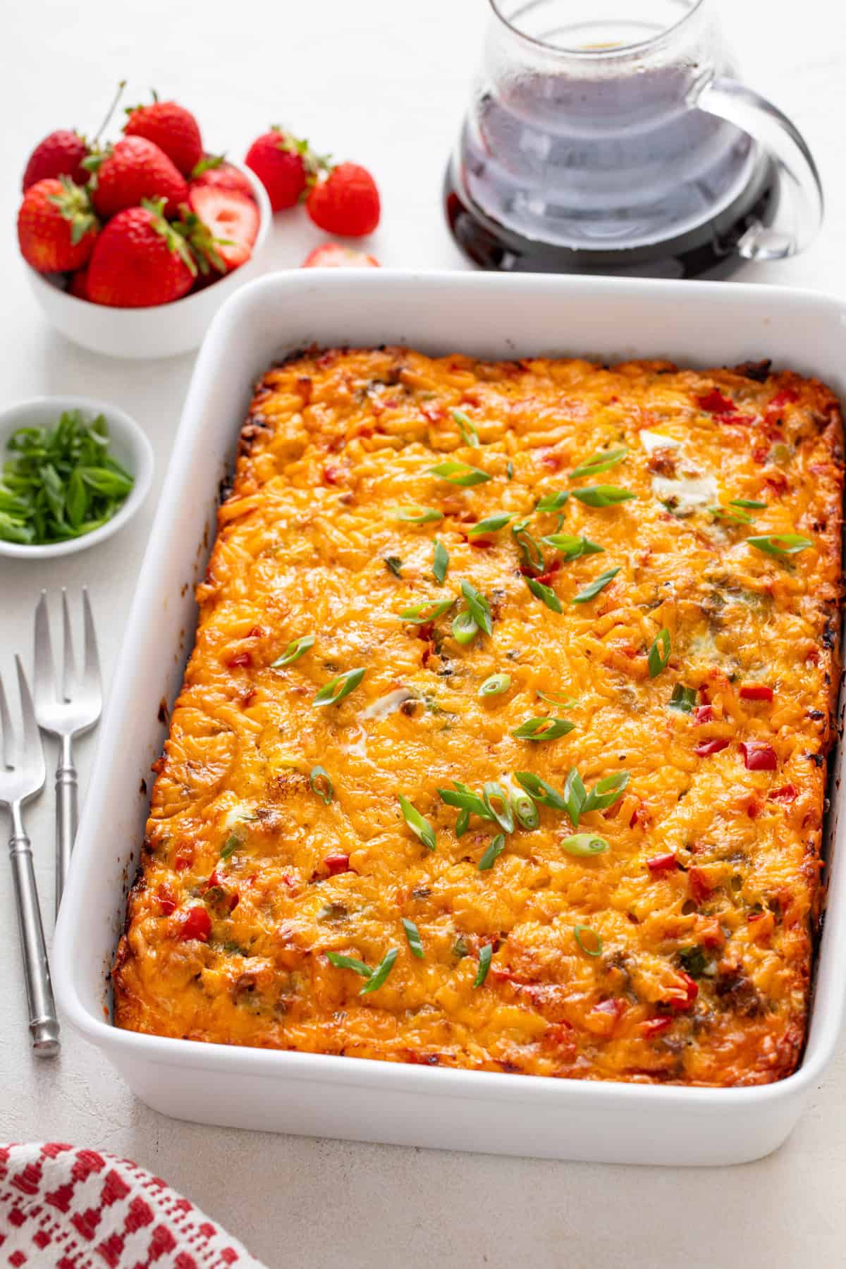 Baked christmas breakfast casserole in a white baking dish.