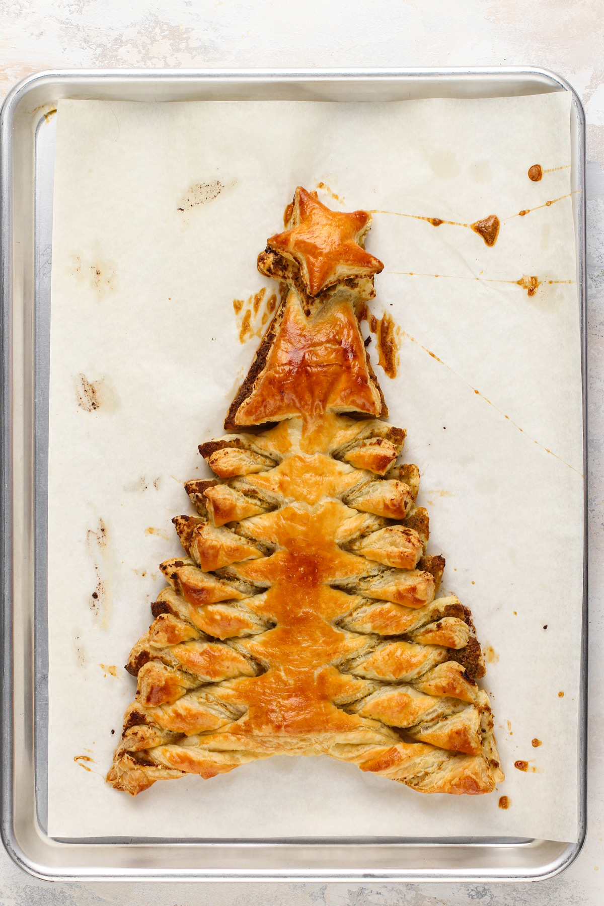 Baked puff pastry christmas tree filled with basil pesto.