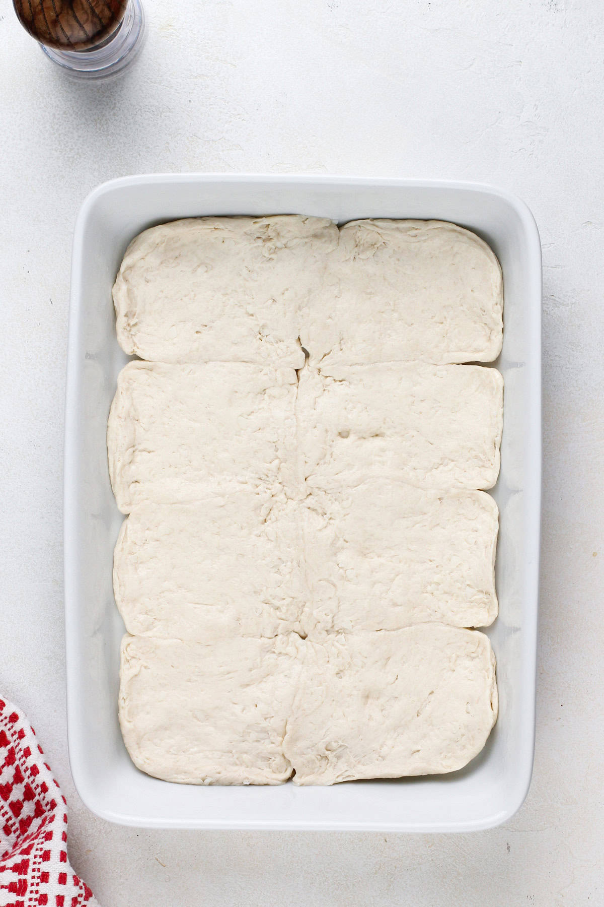 Canned biscuits pressed into the bottom of a baking dish.