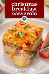 Forking cutting a corner from a slice of christmas breakfast casserole. Text overlay includes recipe name.