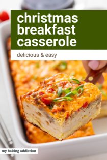 Hand using a spatula to lift up a slice of christmas breakfast casserole. Text overlay includes recipe name.