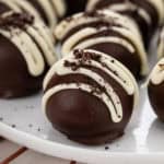 Close up of an Oreo truffle on a white plate.