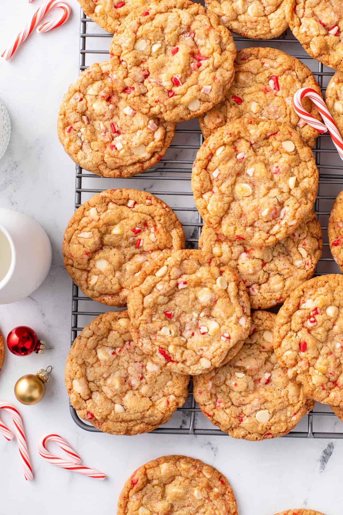 Overhead view of white chocolate peppermint cookies arranged on a wire rack.