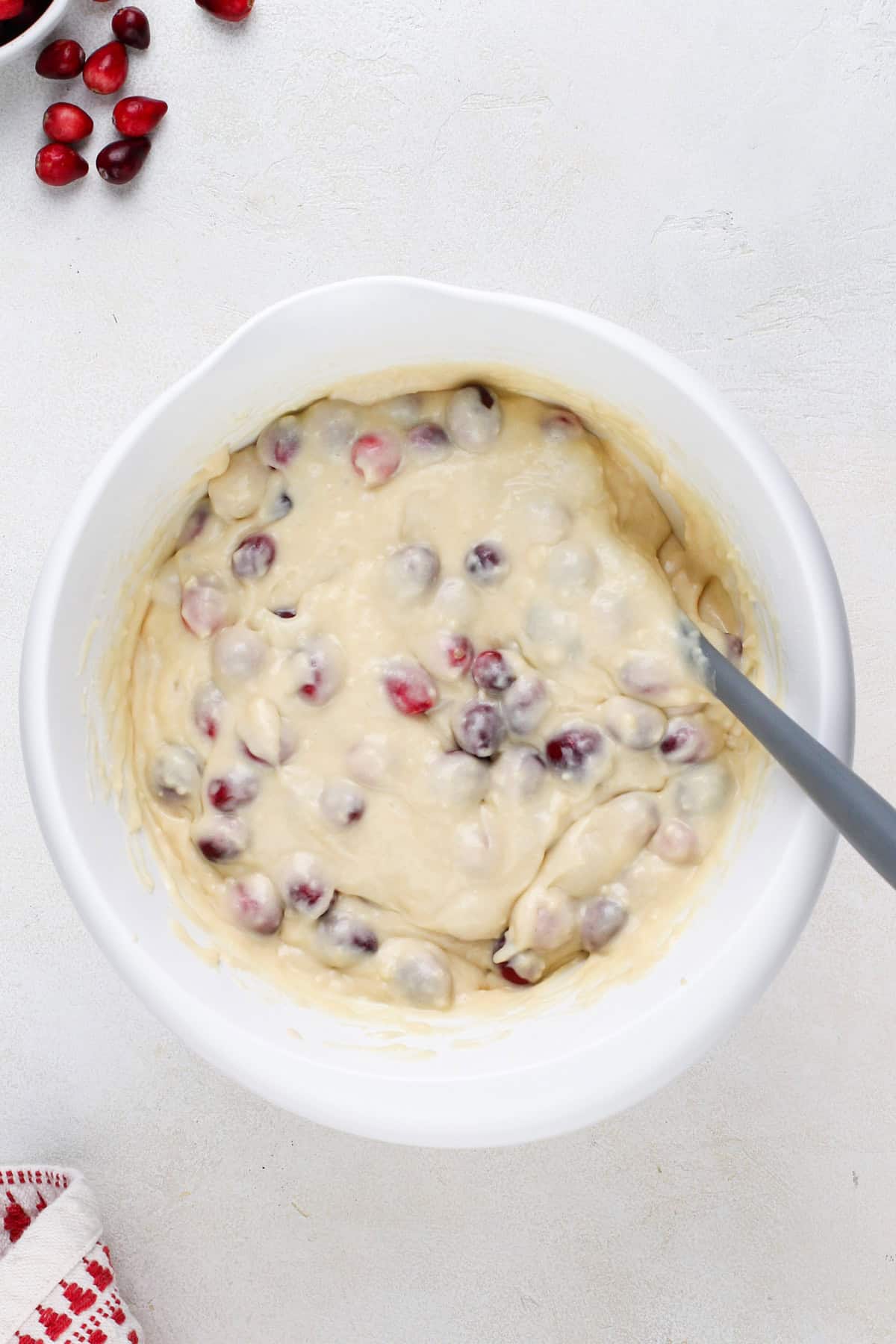 Cranberry cake batter mixed in a white bowl.