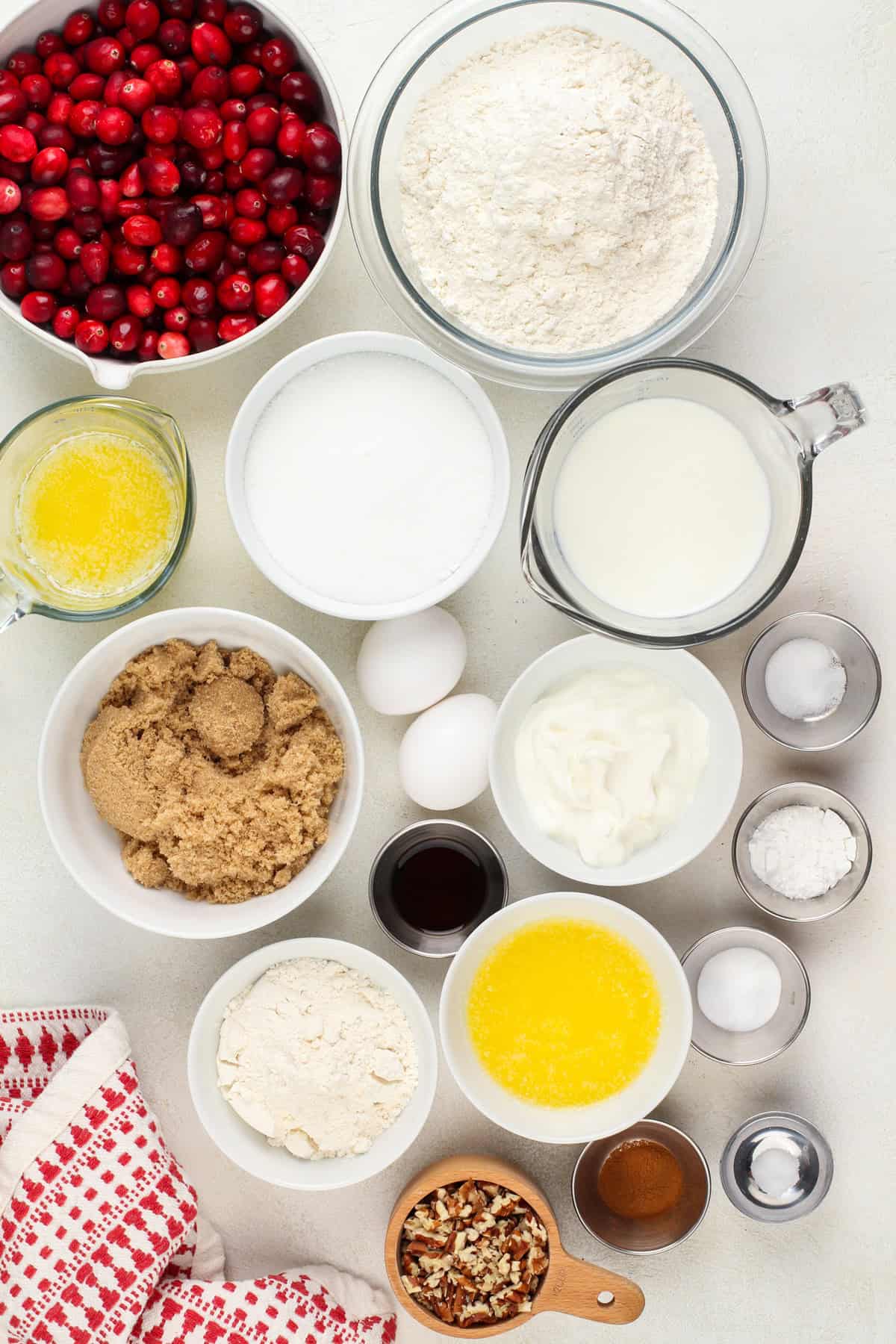 Ingredients for cranberry cake arranged on a countertop.