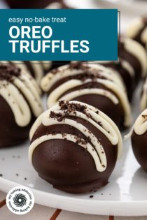 Close up of Oreo truffles drizzled with white chocolate and topped with oreo crumbs on a white plate. Text overlay includes recipe name.