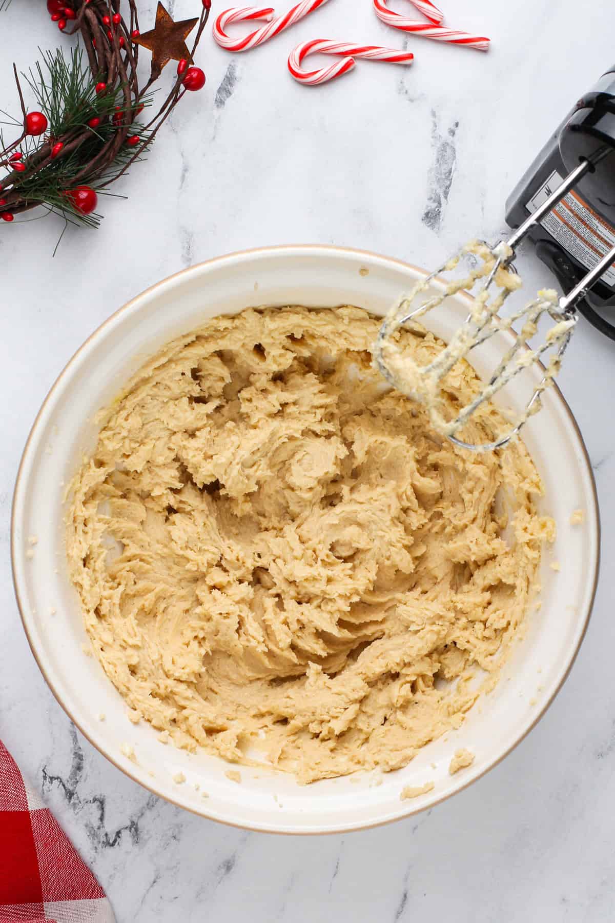 Wet ingredients for white chocolate peppermint cookies mixed in a ceramic bowl.