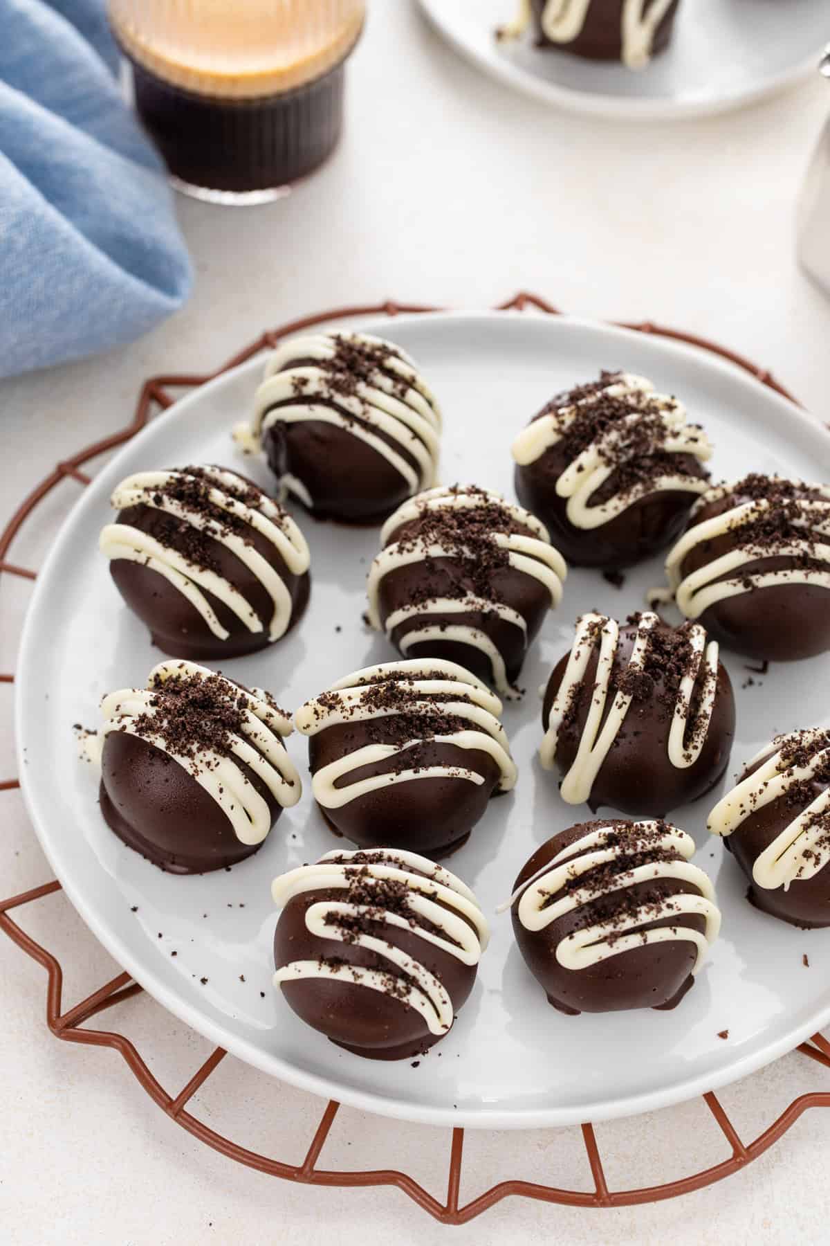 Oreo truffles arranged on a white plate.