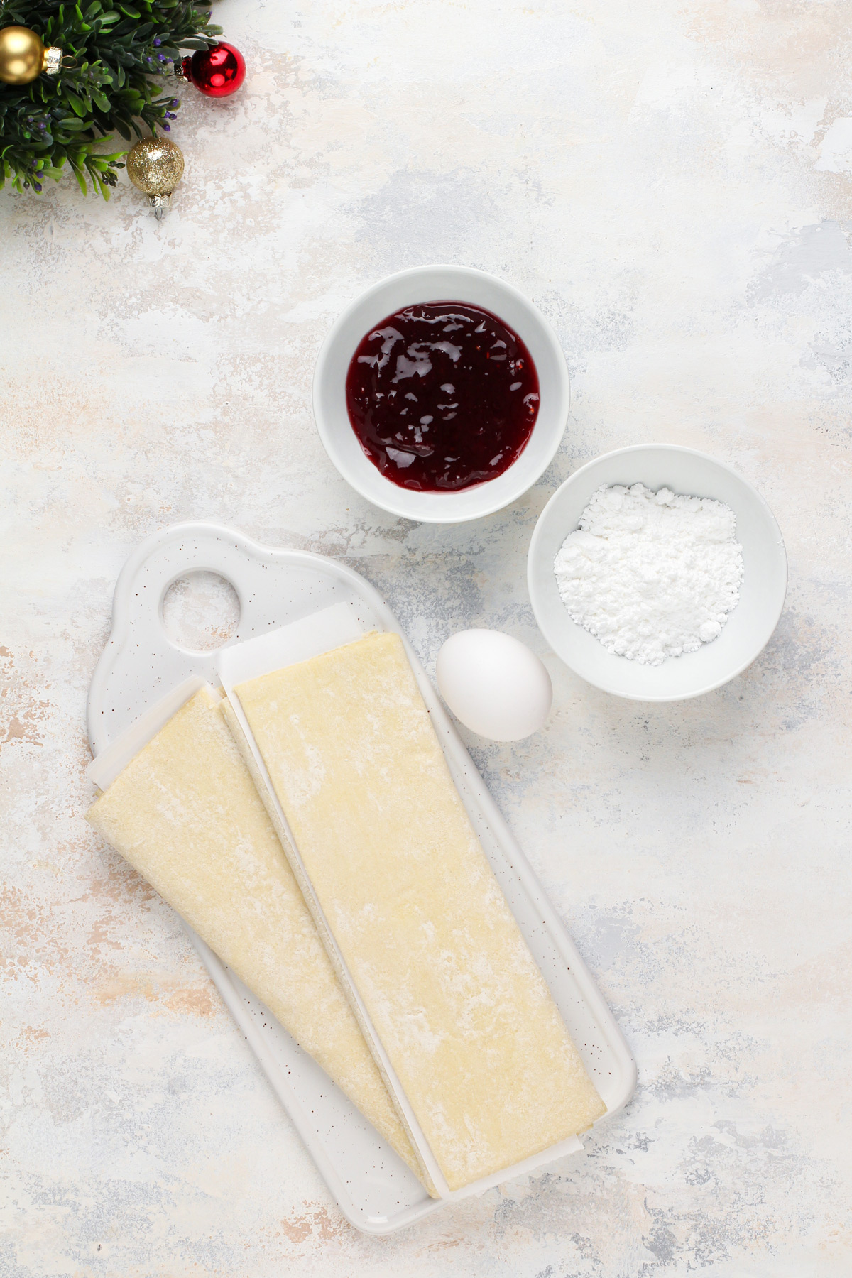 Ingredients for a puff pastry christmas tree arranged on a countertop.