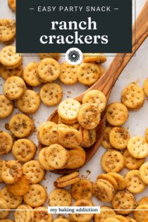 Wooden spoon about to lift a scoopful of ranch crackers off a baking sheet. Text overlay includes recipe name.