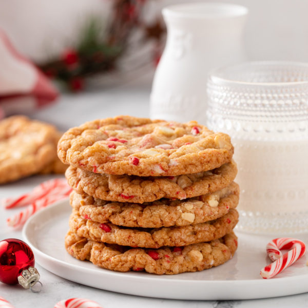 Stacked white chocolate peppermint cookies on a white plate.