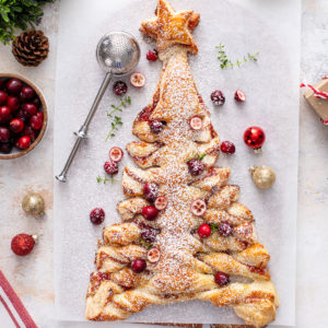 Overhead view of a sweet puff pastry christmas tree dusted in powdered sugar.