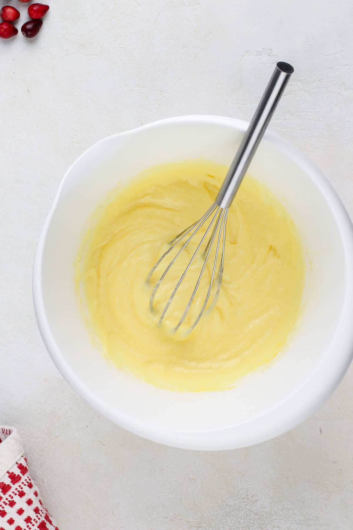 Butter, sugar, and eggs whisked in a bowl.