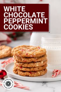 Side view of 5 stacked white chocolate peppermint cookies in front of a glass of milk on a white plate. Text overlay includes recipe name.